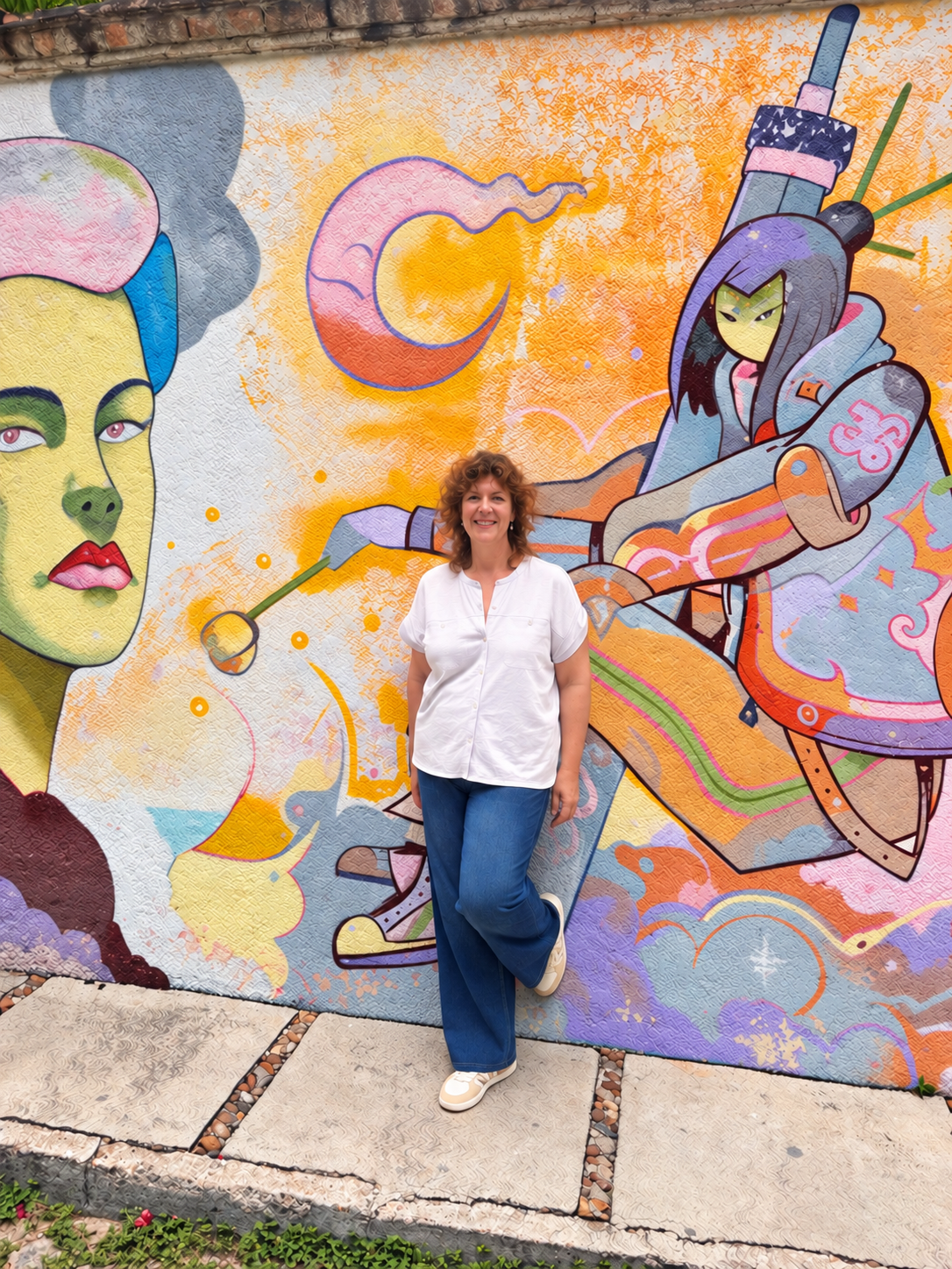 Elizabeth Bunnell standing beside a painted mural